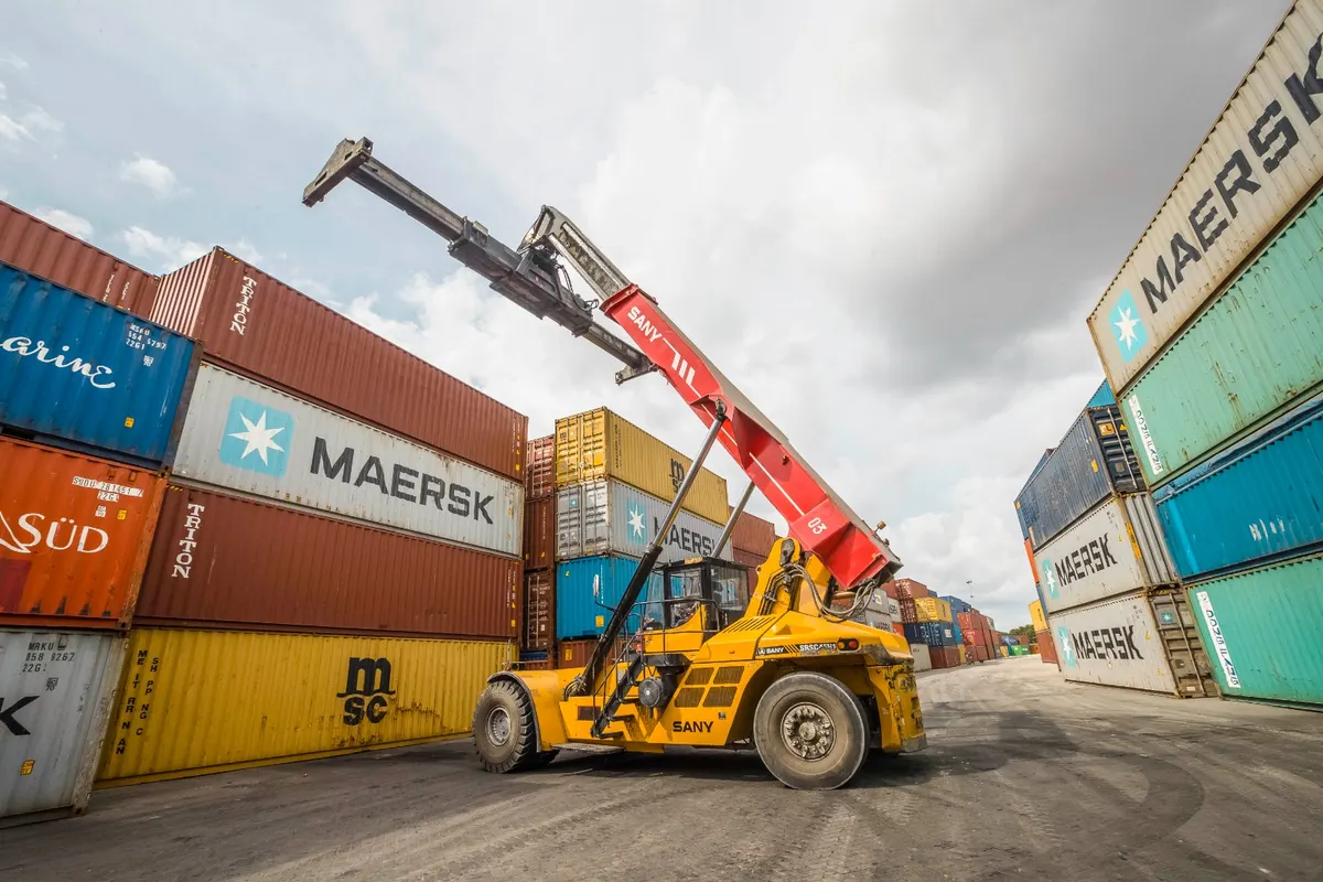 Reach stacker working between stacked containers at AFICD